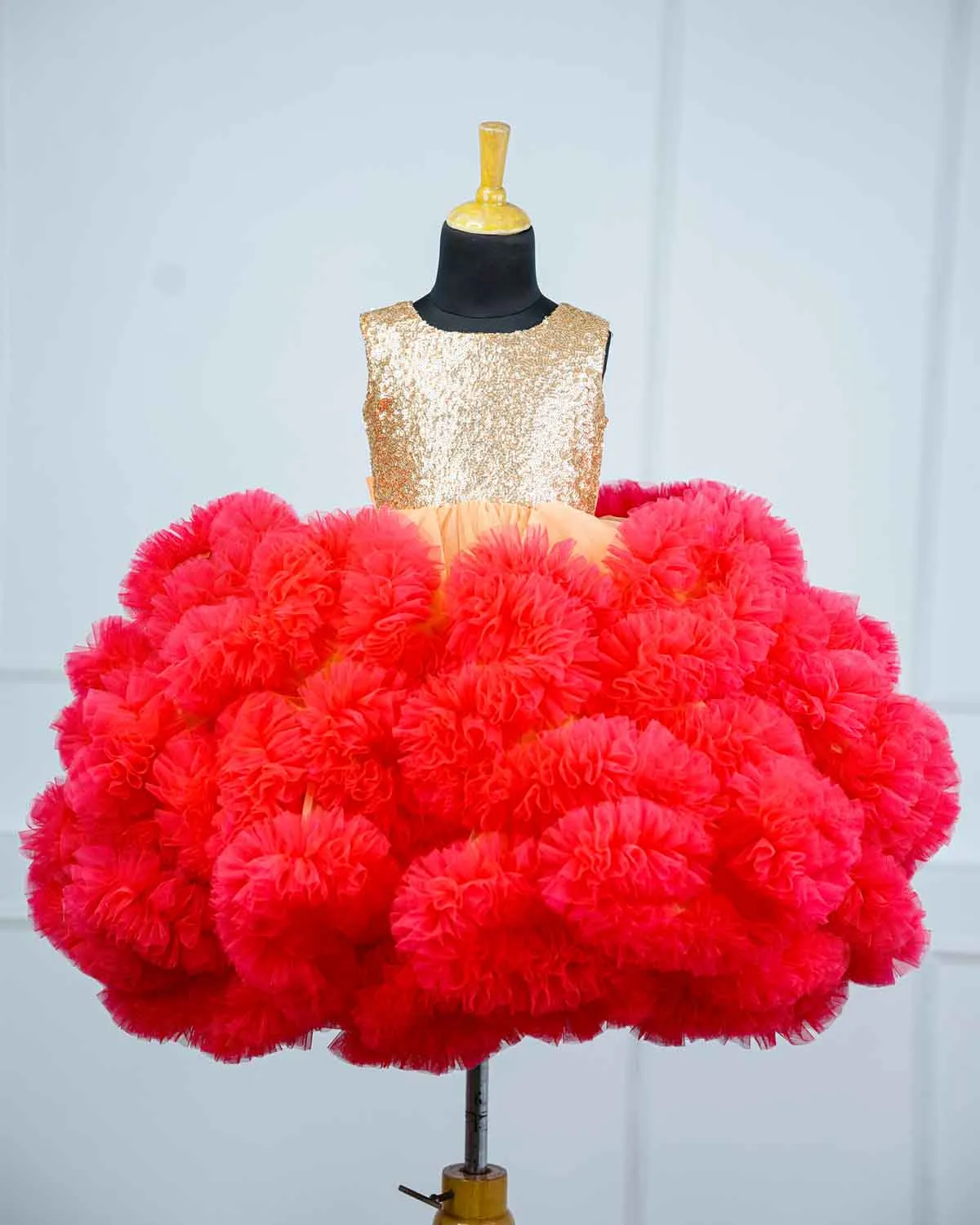 Peach and Coral pink cloudy frilled gown with golden sequins yoke