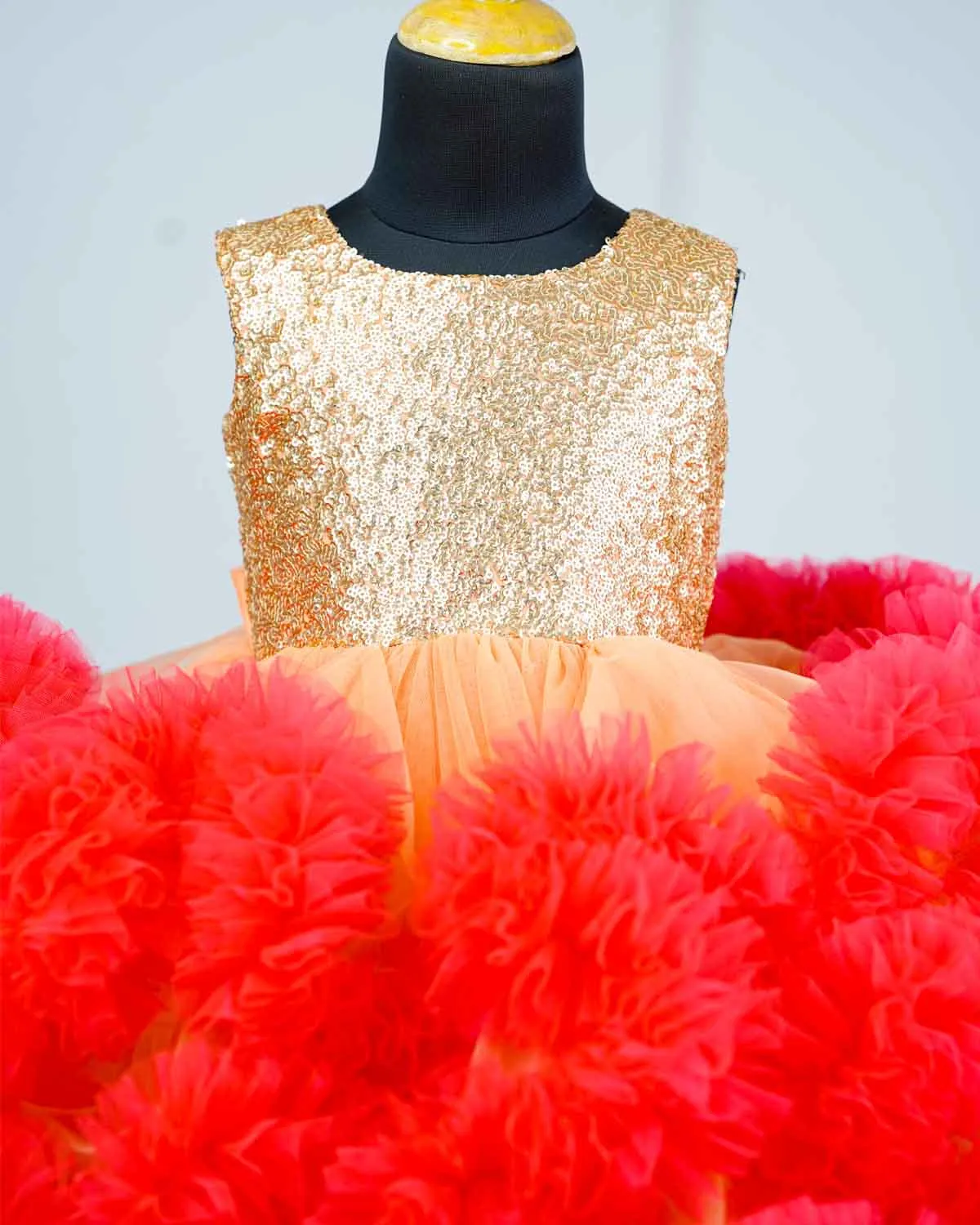 Peach and Coral pink cloudy frilled gown with golden sequins yoke